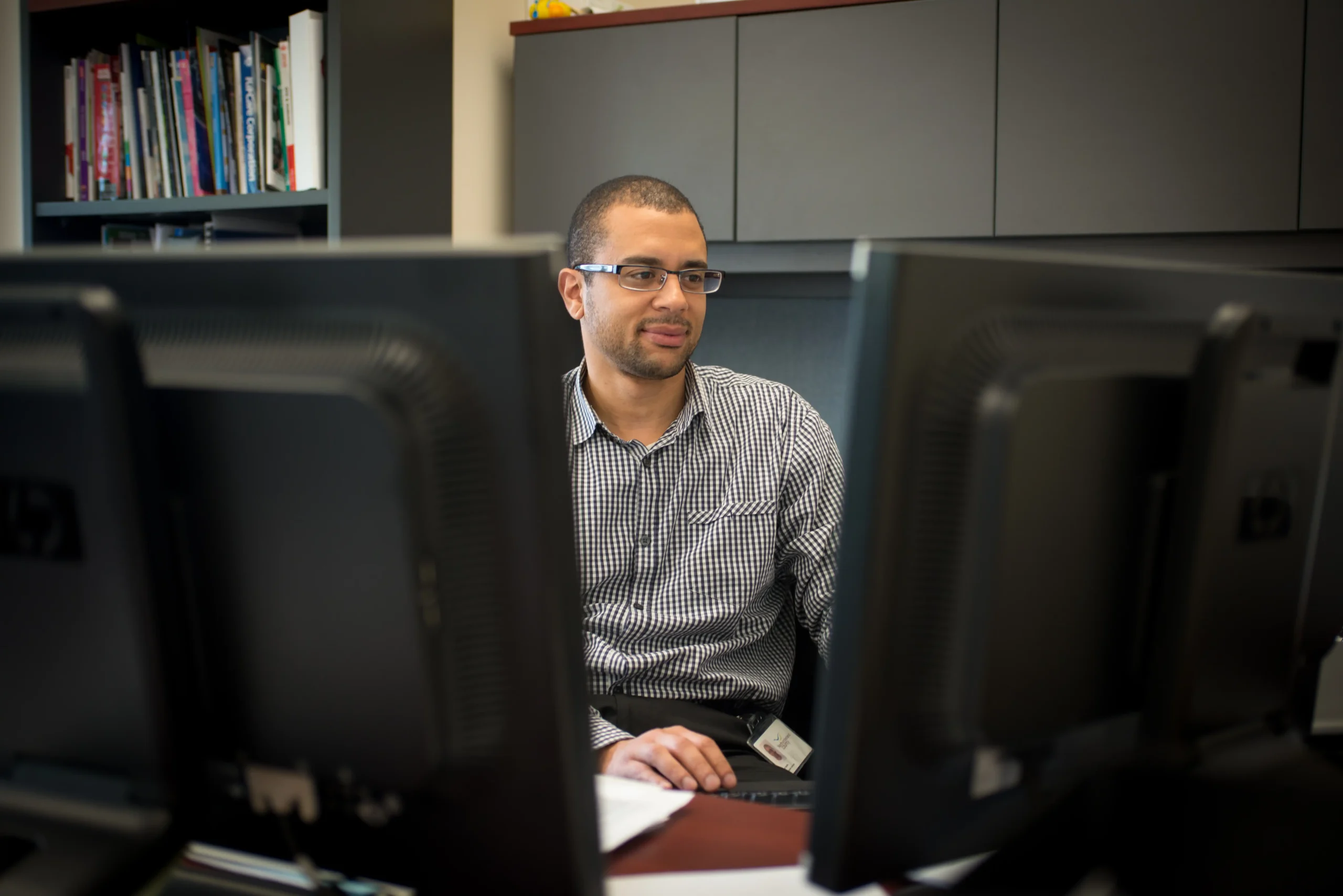 staff behind computer screen
