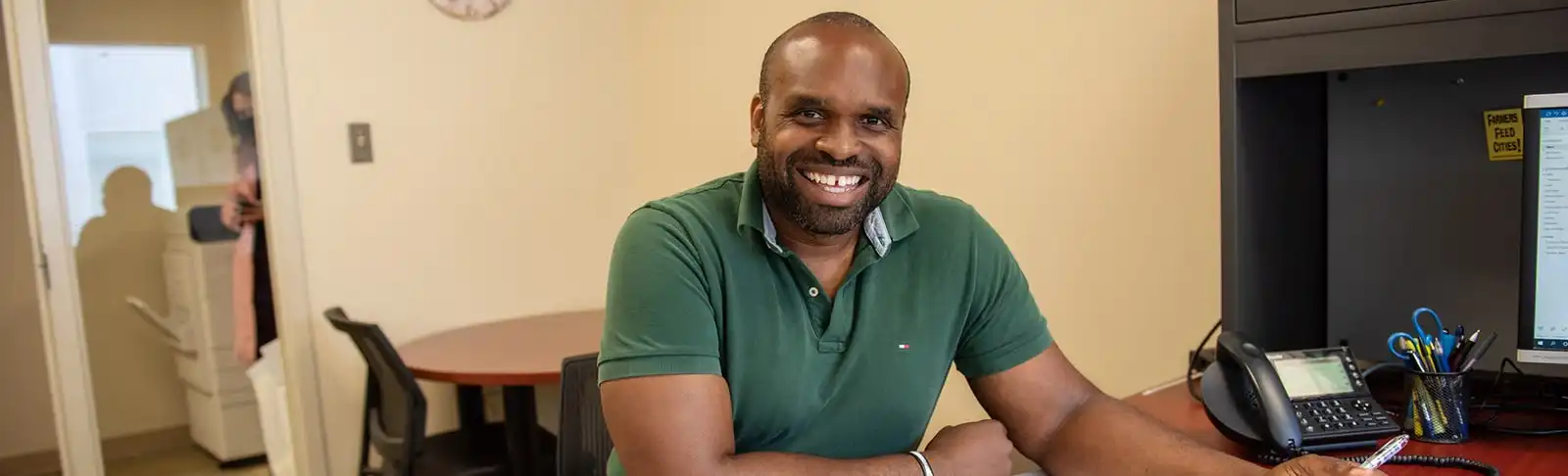 Planning staff smiles at desk
