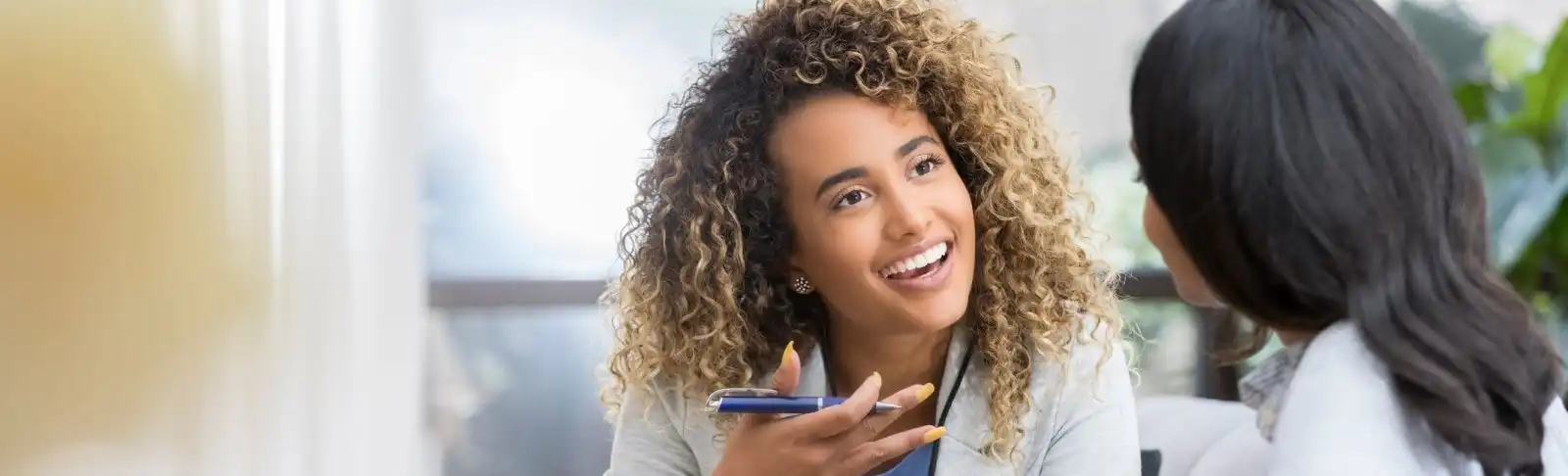 Woman smiles as she talks to client