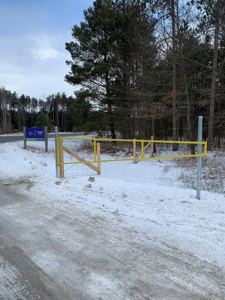 Trailhead parking lot entry with yellow gate