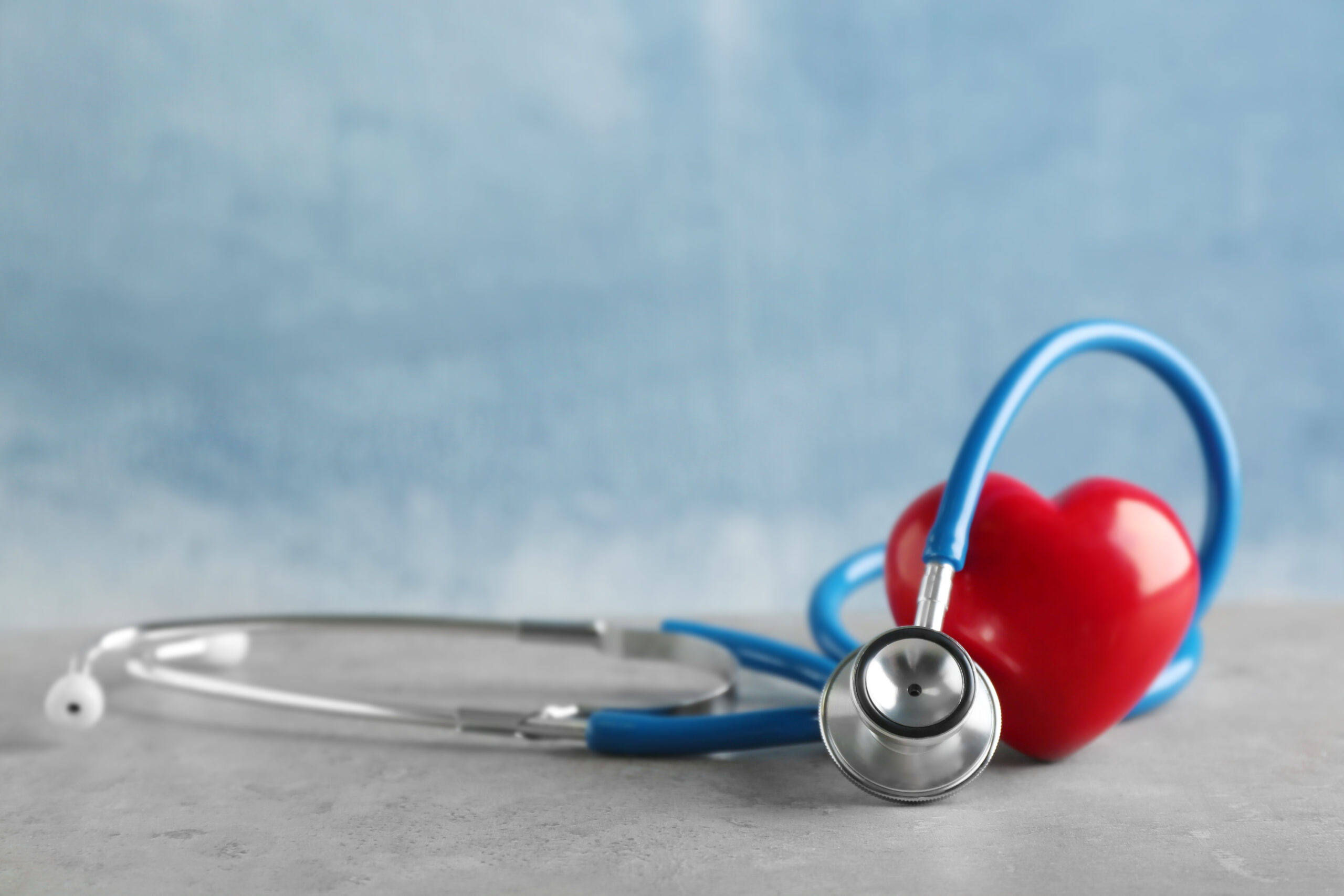 Stethoscope and red heart on table
