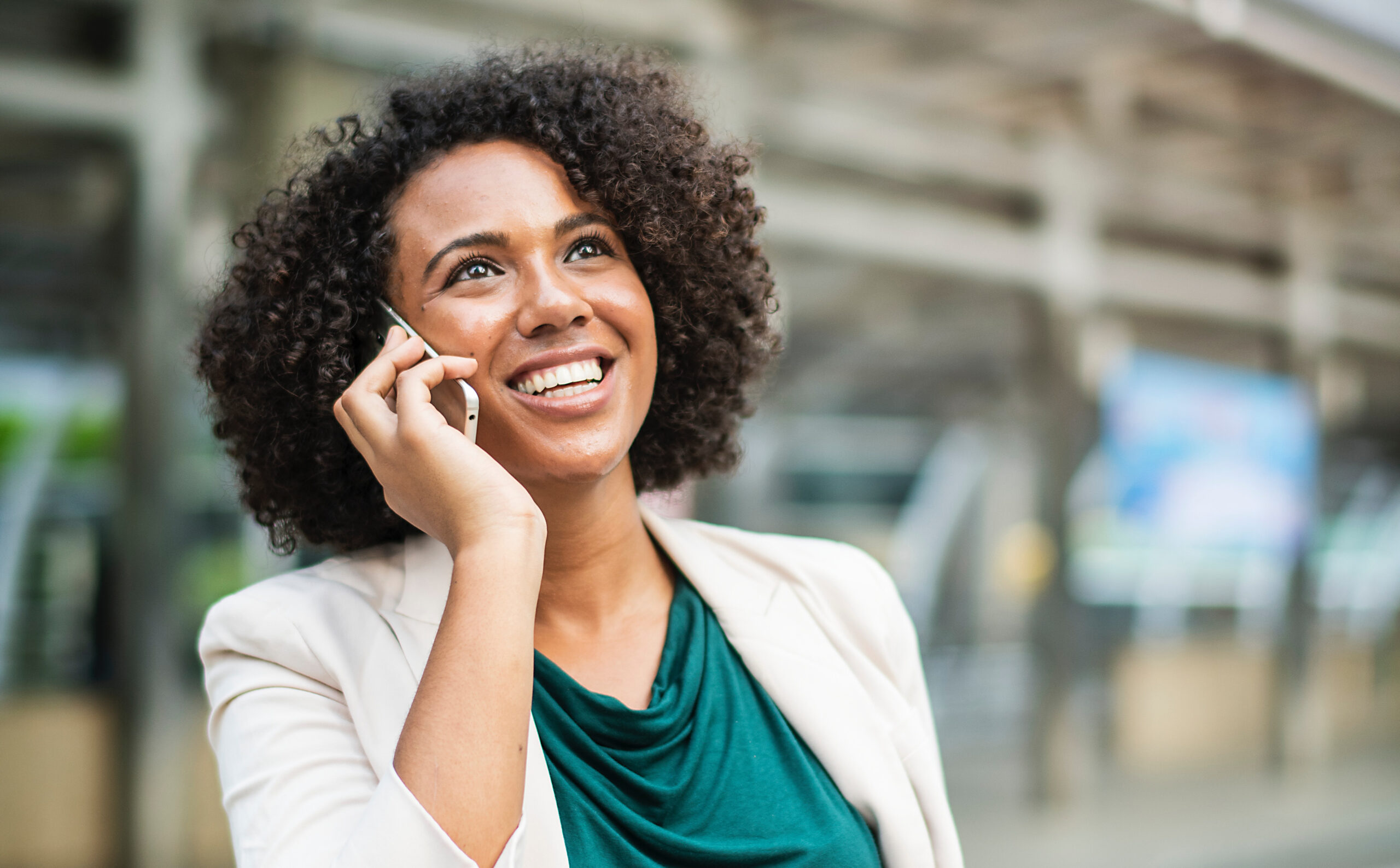 Woman smiles while on a phone call