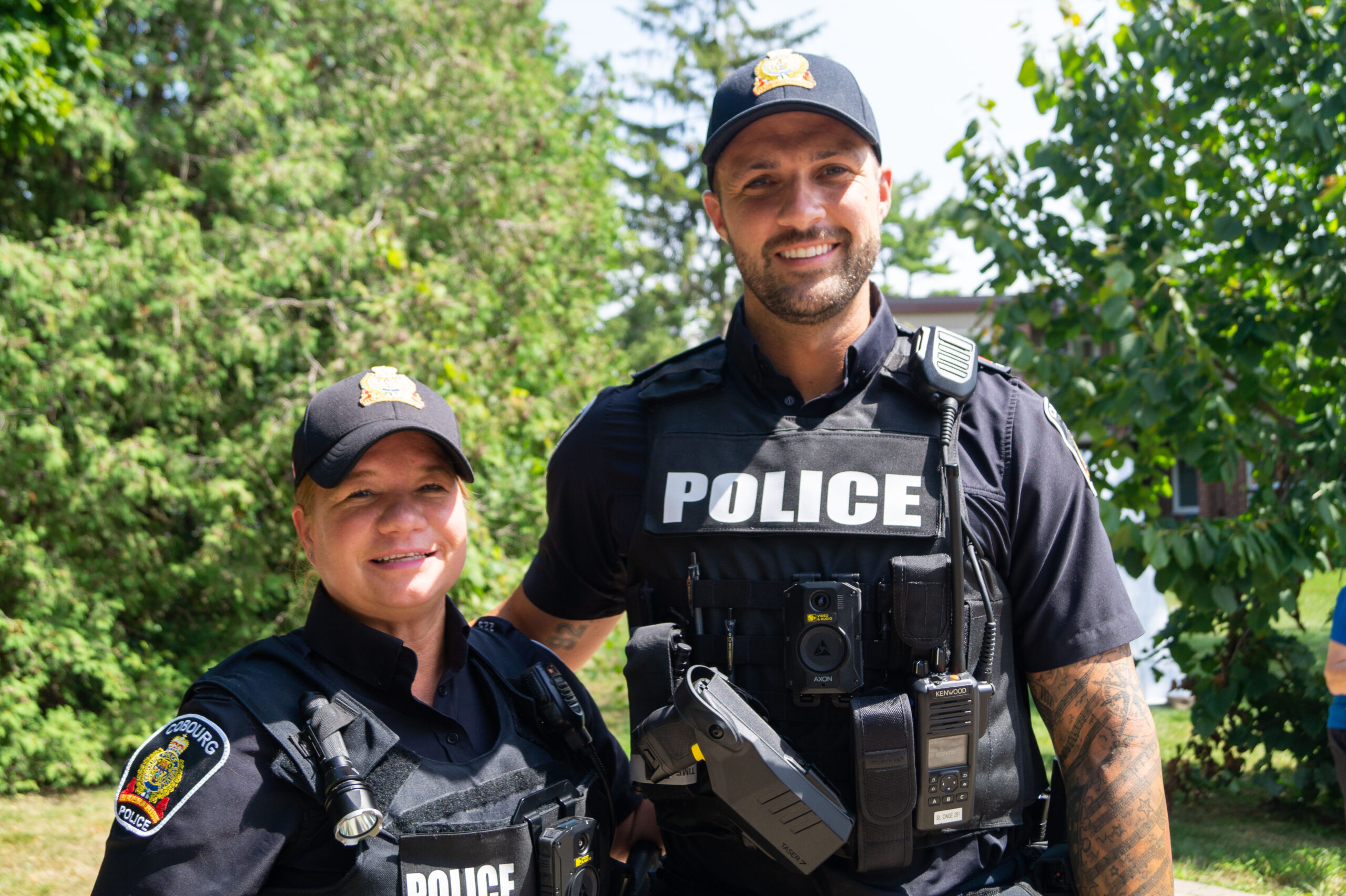 Two police officers smile