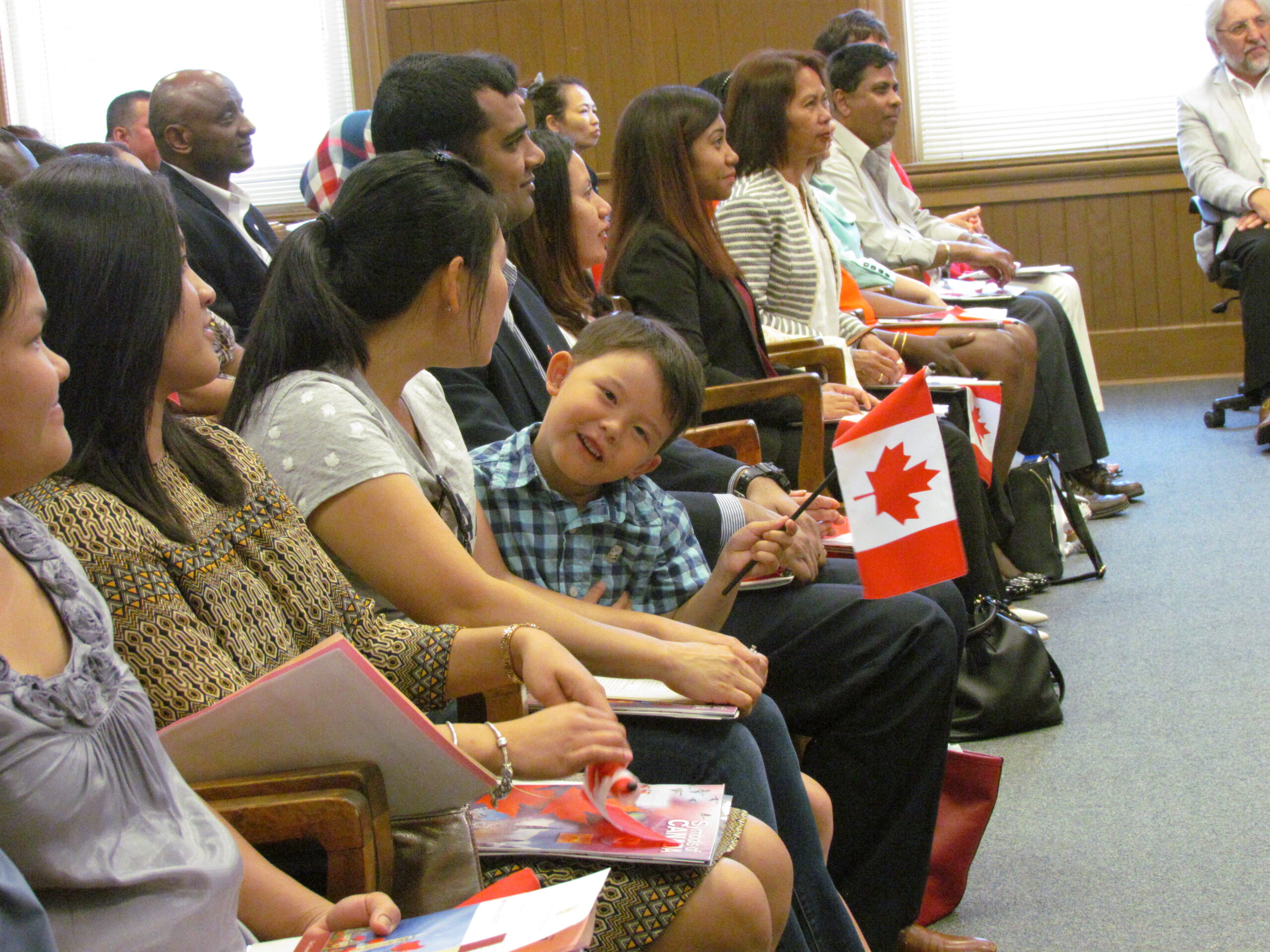 Kid smiles while holding canada flag