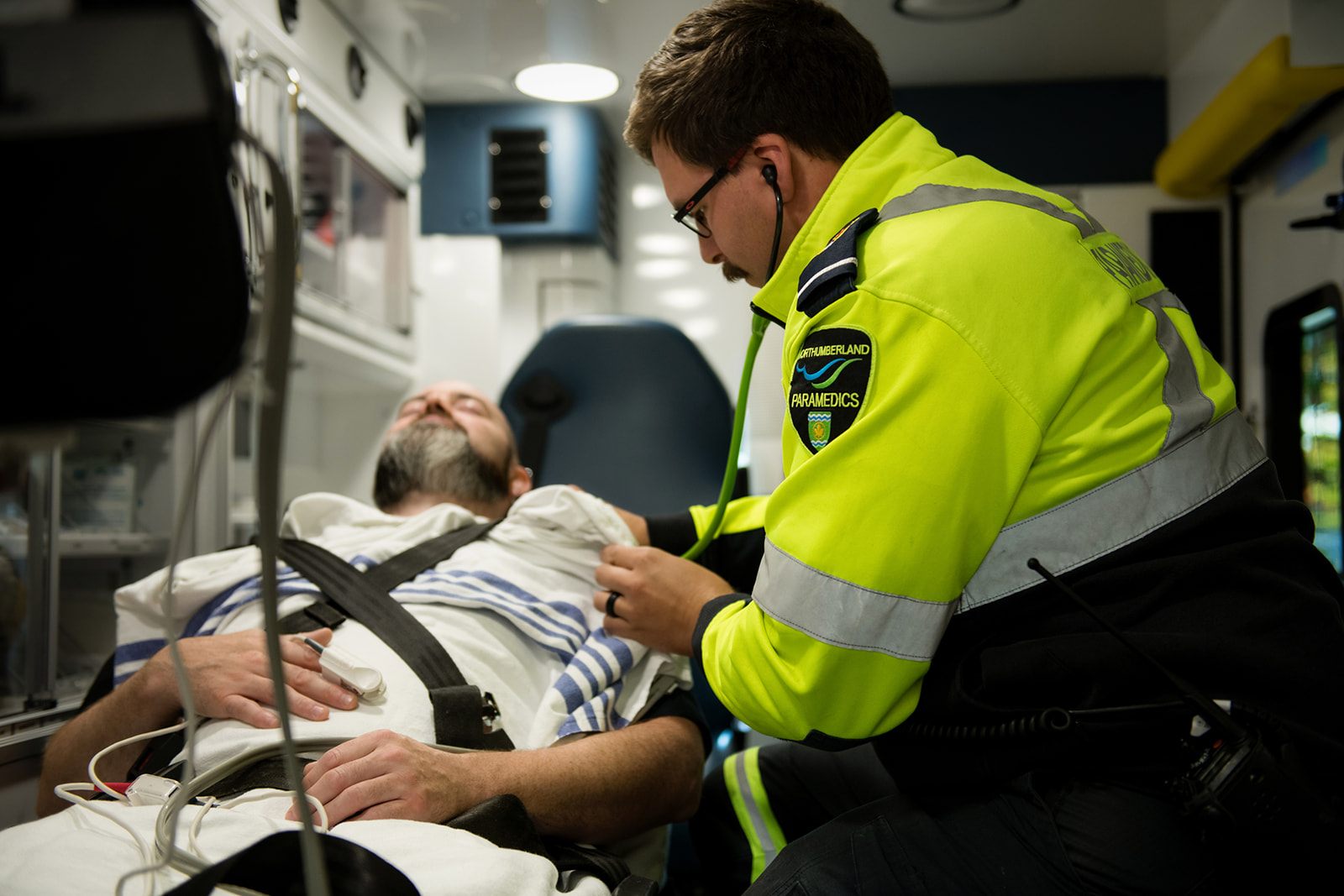 Paramedic treats patient in ambulance