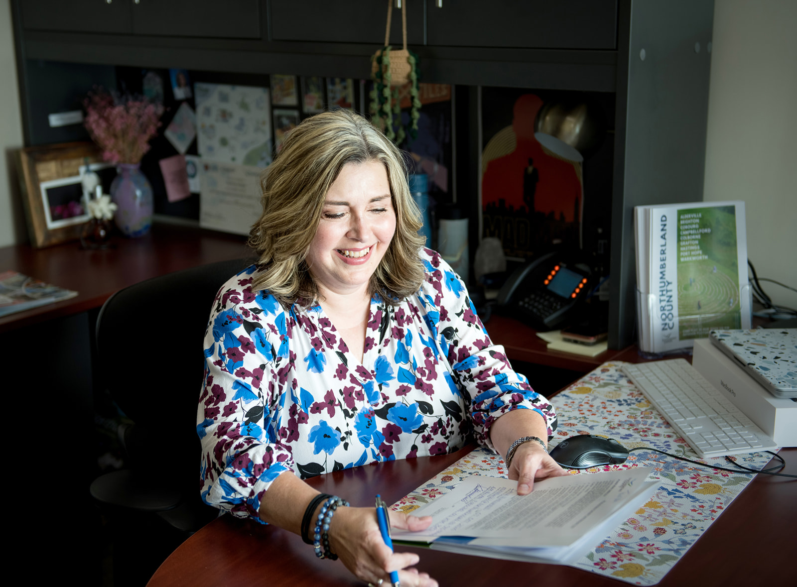 Staff smiles at their desk