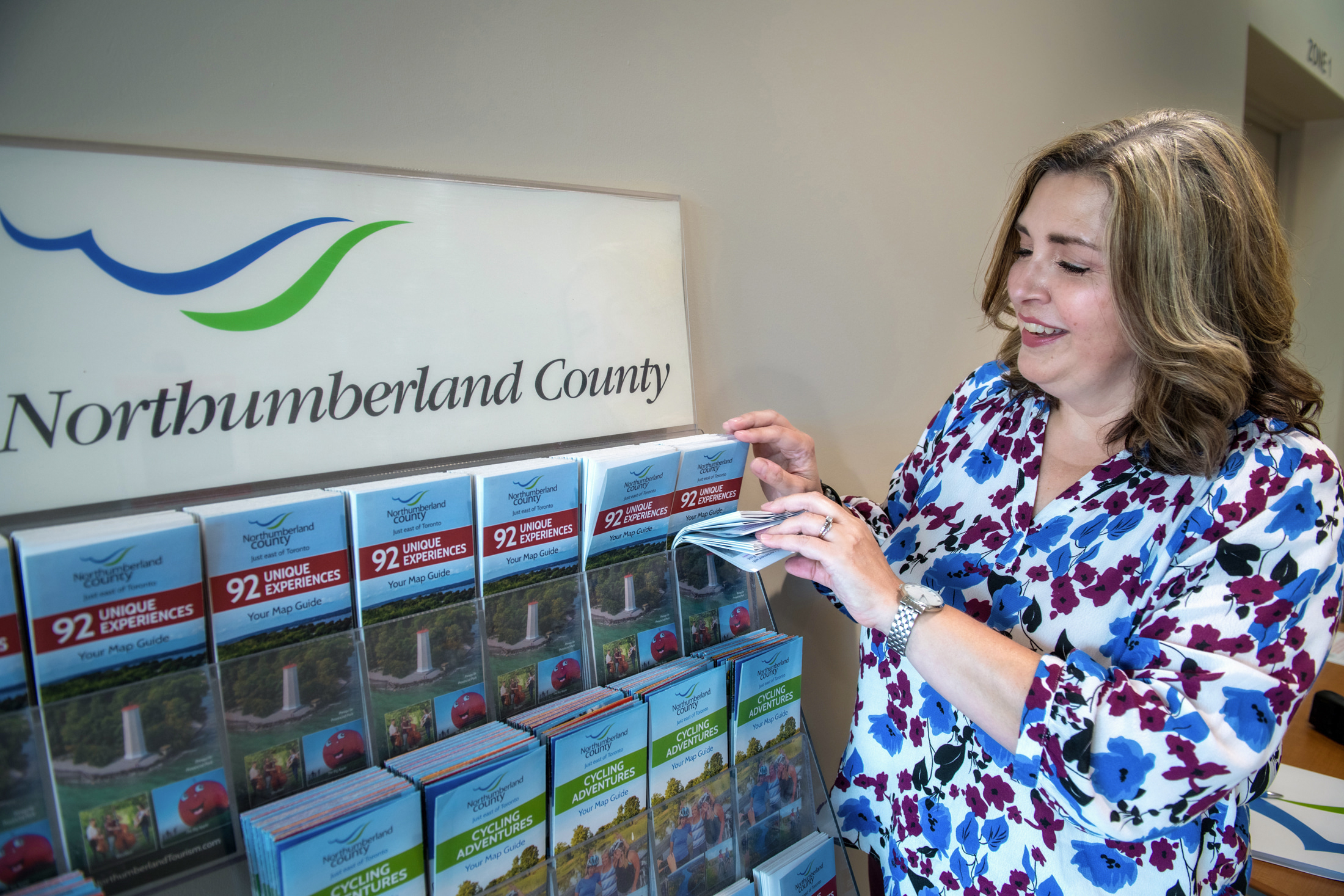 Northumberland Tourism staff member restocks Tourism brochures