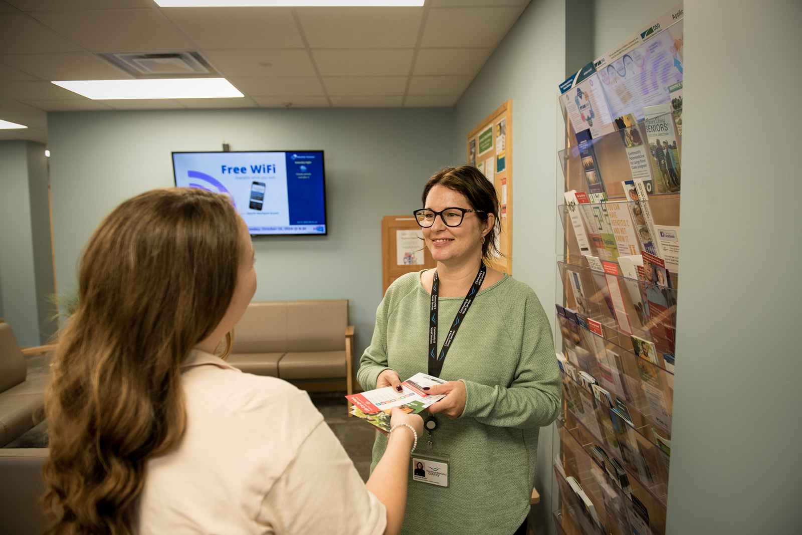 Social Services staff chats with client