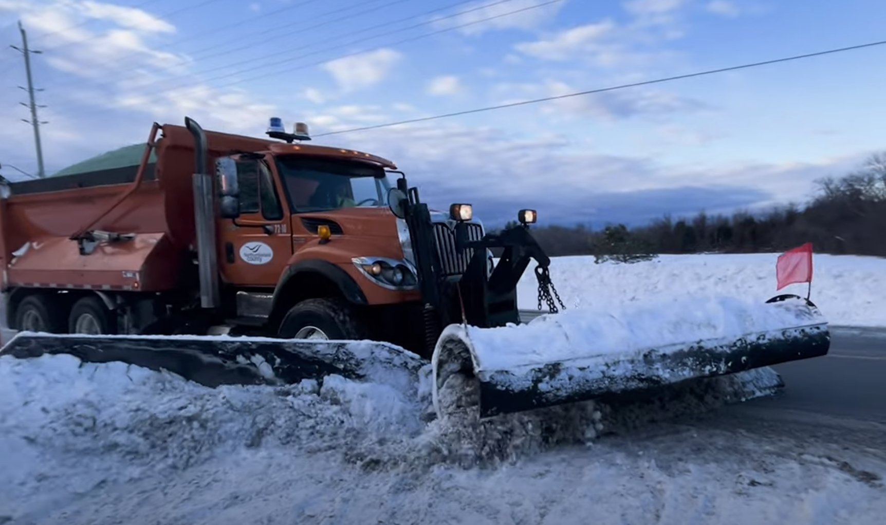 Snow plow clearing road