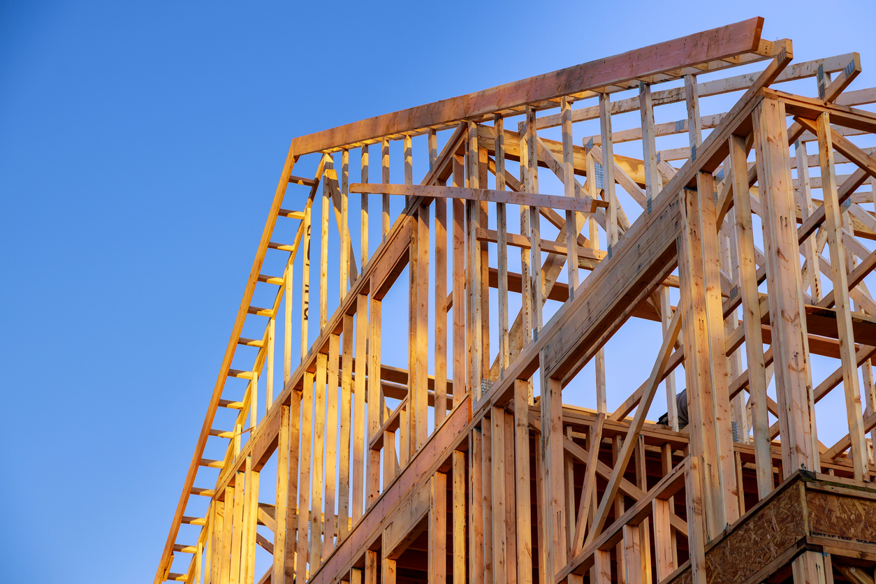 New construction home residential construction home framing against a blue sky
