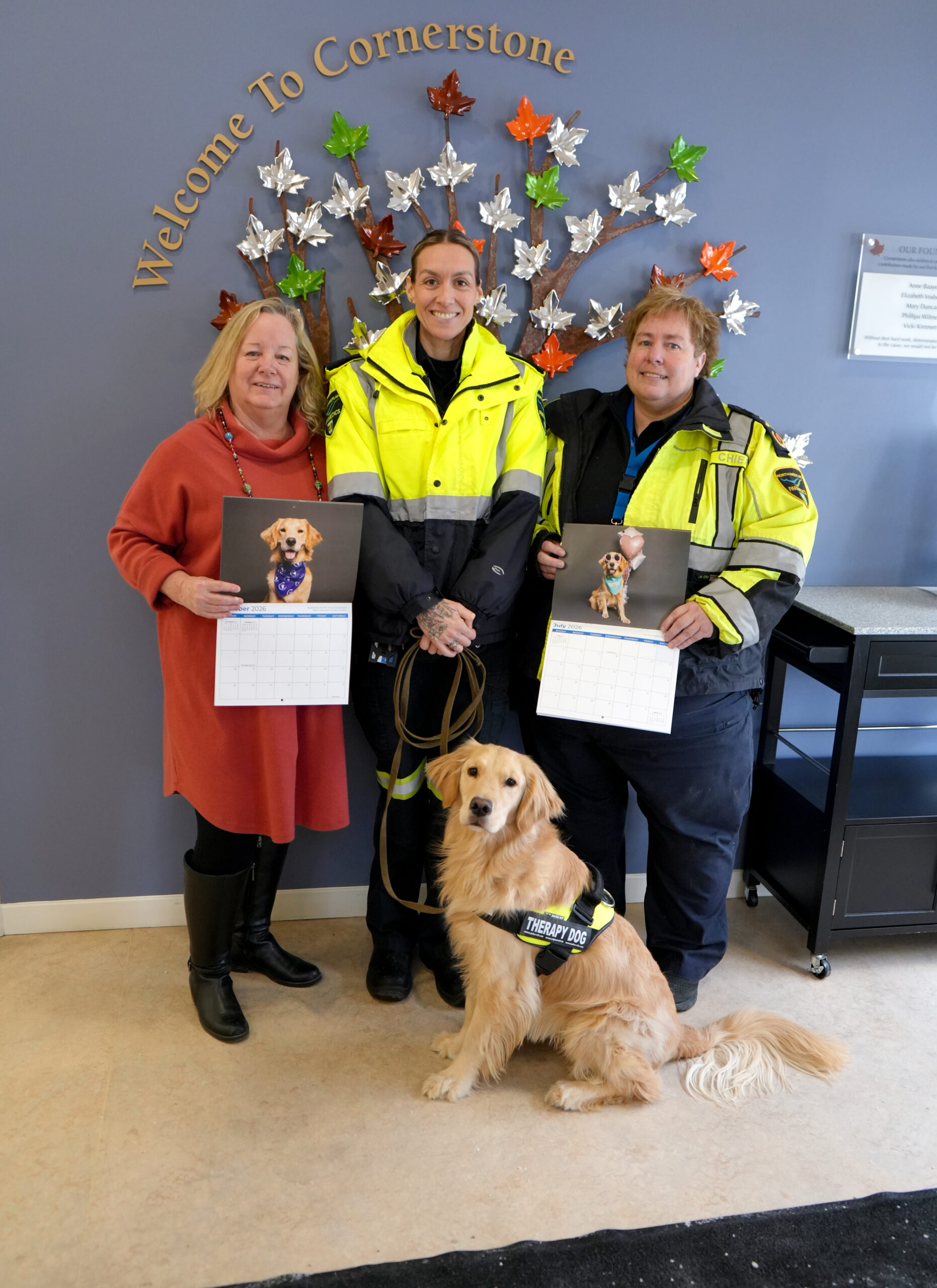 Left to Right—Cornerstone Family Violence Prevention Centre Executive Director Nancy Johnston, Northumberland Paramedics Superintendent of of Quality Improvement Education Giselle Lech, Northumberland Paramedics Chief Susan Brown, Northumberland Paramedics Therapy Dog Ivy Joules